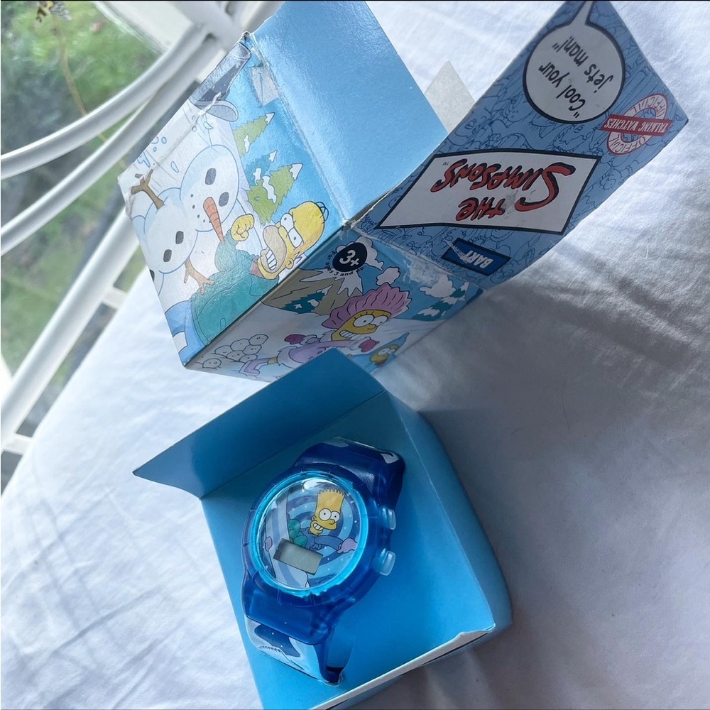 Vintage The Simpsons blue digital watch from Burger King. Bart snowboarding.